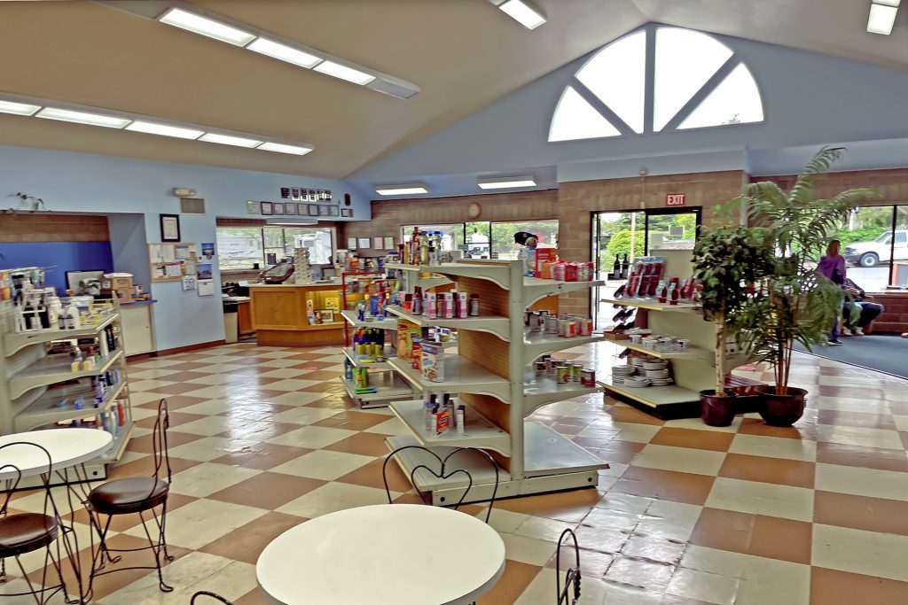 large shop with checkered floor and various convenience goods
